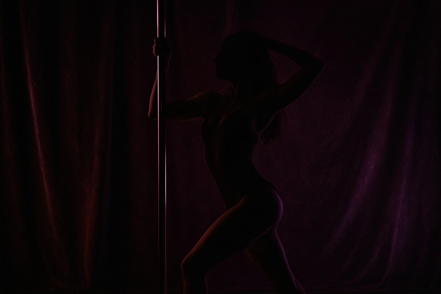 Dark sensual background with burgundy and purple lighting